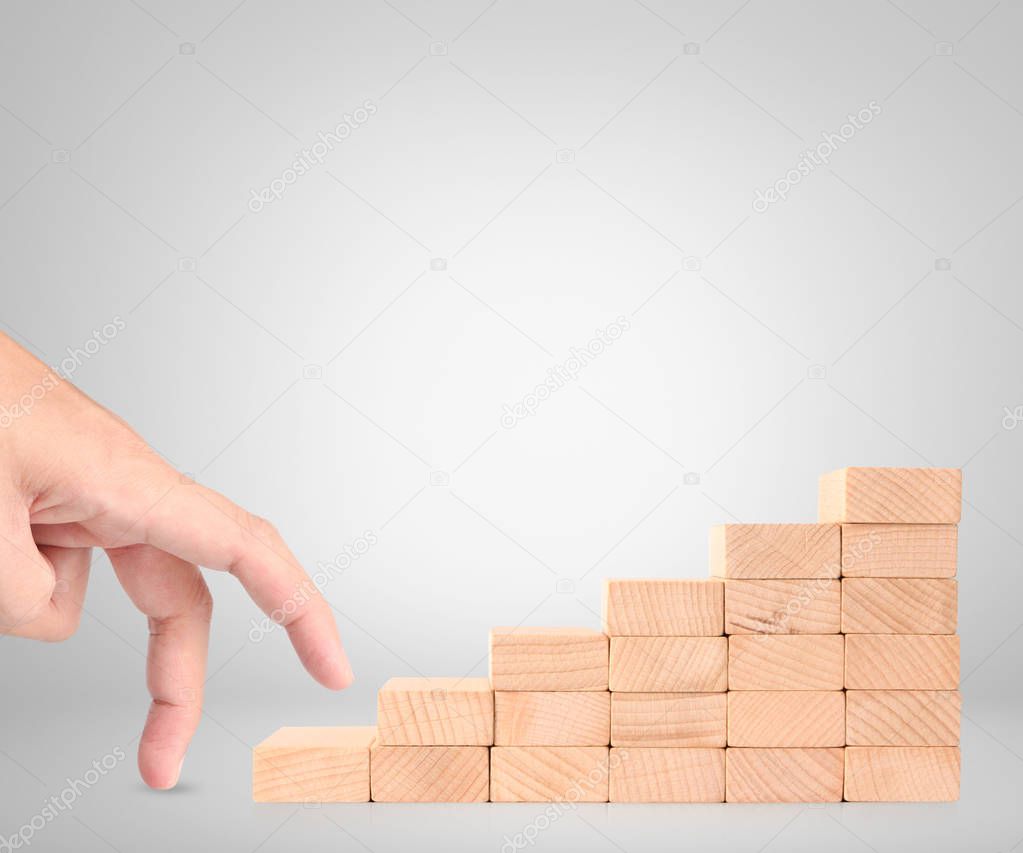 Hand liken business person stepping up  toy staircase