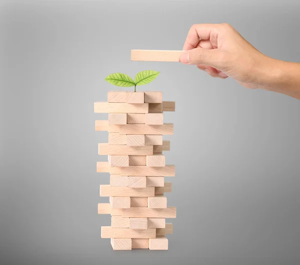 hand playing wood blocks stack game