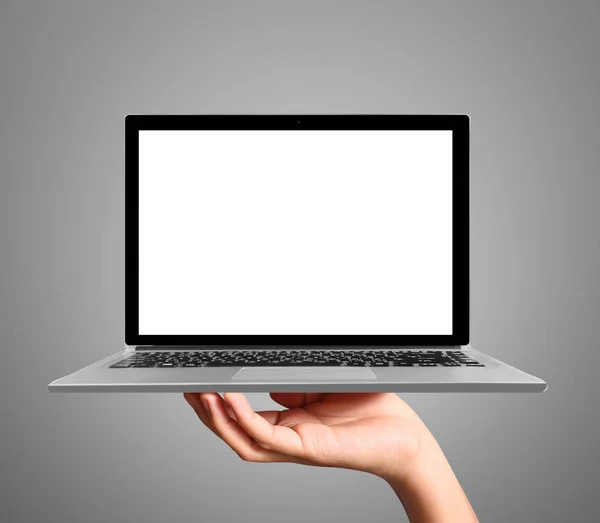 Hand holding a laptop — Stockfoto