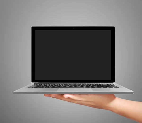 Hand holding a laptop — Stockfoto