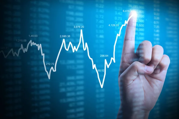 Empresário com símbolos gráficos financeiros provenientes da mão — Fotografia de Stock