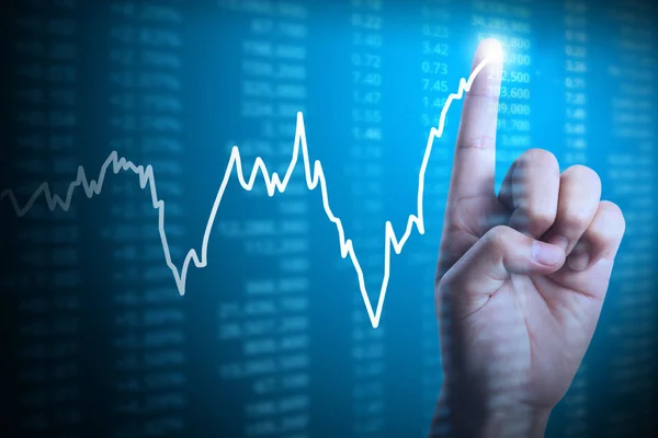 Podnikatel s finanční graf symboly pocházející z ruky — Stock fotografie