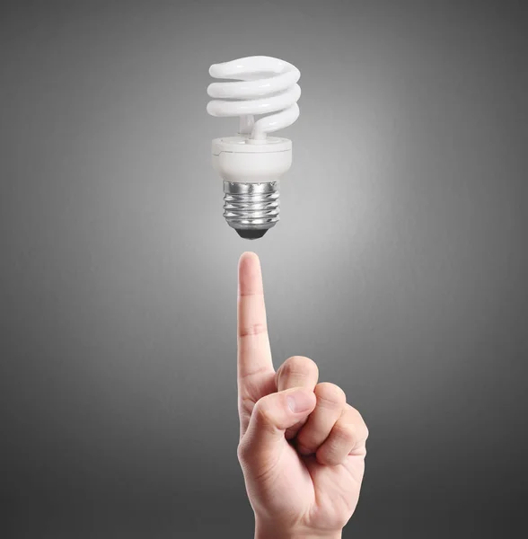 Hand holding light bulb with energy — Stock Photo, Image