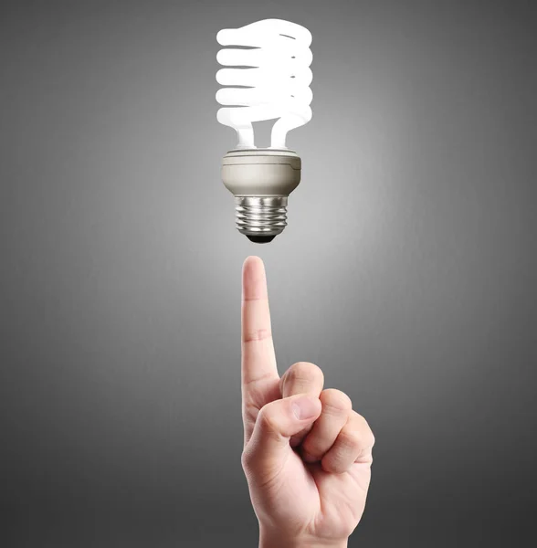 Hand holding light bulb with energy — Stock Photo, Image