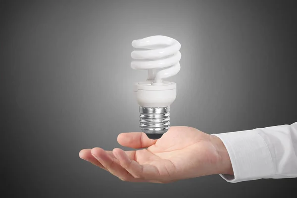 Hand holding light bulb with energy — Stock Photo, Image