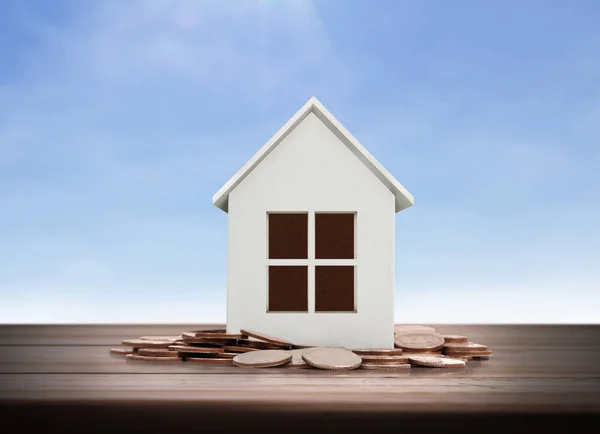 Small house standing on stacks  coins — Stock Photo, Image