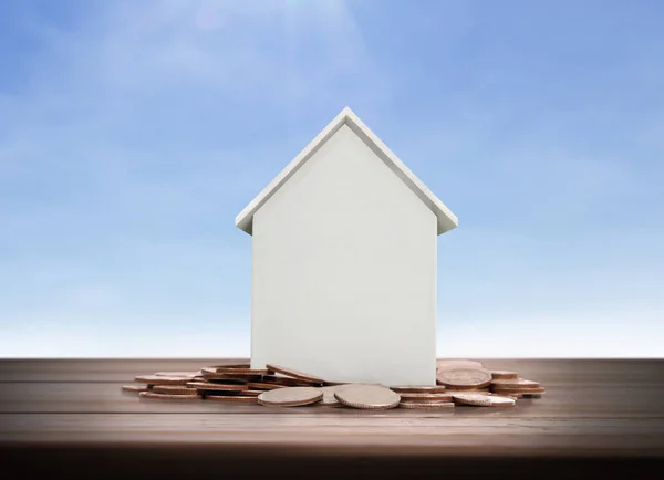 Small house standing on stacks  coins — Stock Photo, Image