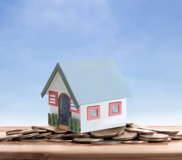 Small house standing on stacks  coins — Stock Photo, Image