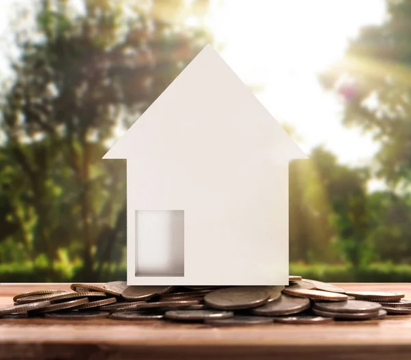 Small house standing on stacks  coins — Stock Photo, Image