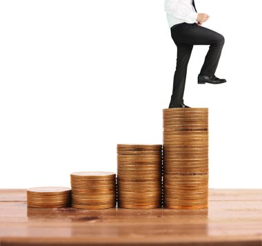 İşadamı, başarı ve yatırımı artıran madeni paraların üzerinde yürüyor