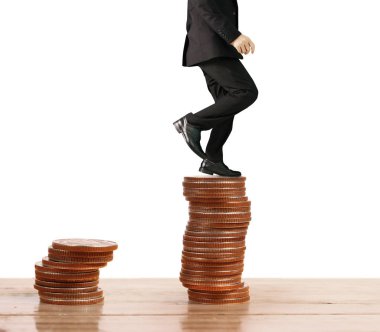 İşadamı, başarı ve yatırımı artıran madeni paraların üzerinde yürüyor