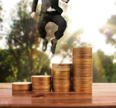 İşadamı yürümek sikkelerin yığın üzerinde başarı yetişen 