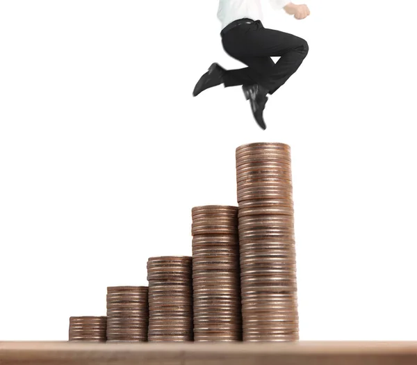 Businessman walk on stack of coins which grows success — Stock Photo, Image