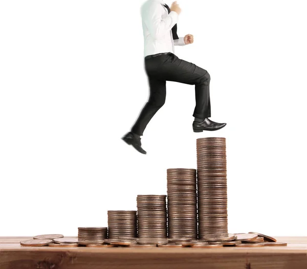 Businessman walk on stack of coins which grows success — Stock Photo, Image