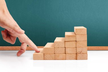 Oyuncak merdivenlere tırmanan el yapımı iş adamı.