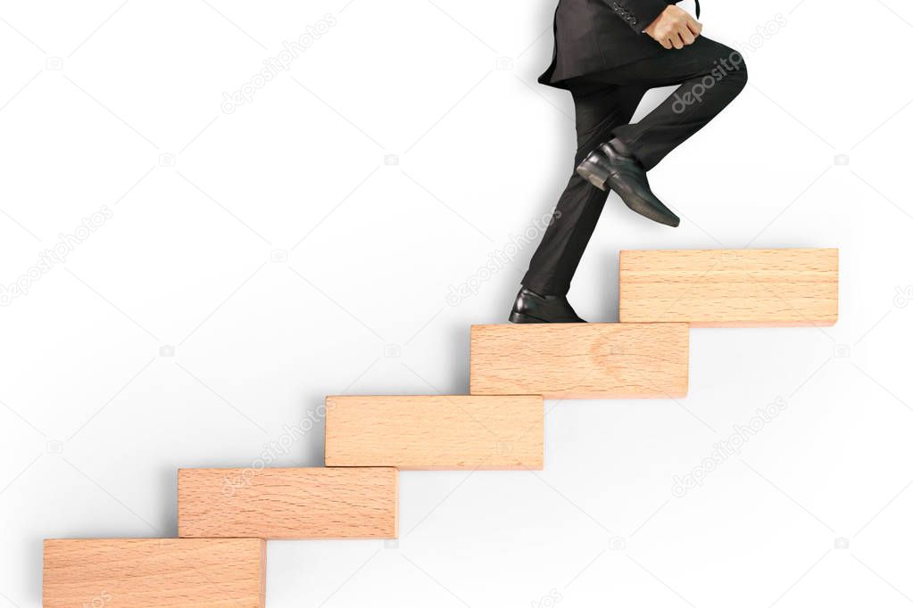 business person stepping up a toy staircase