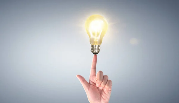Hand of holding illuminated light bulb, idea, innovation inspira — ストック写真