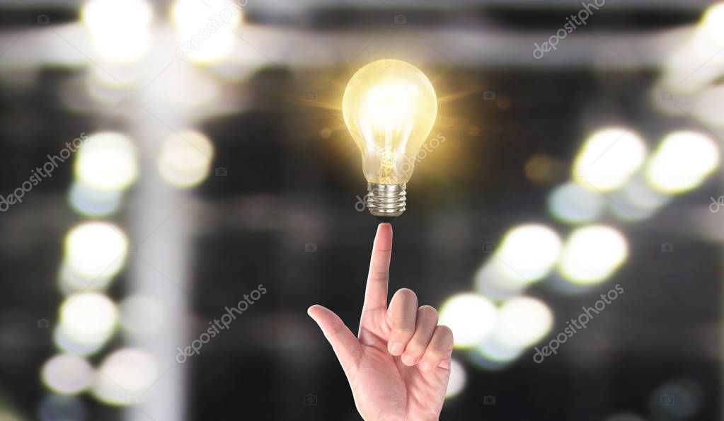 Hand of holding illuminated light bulb, idea, innovation inspira