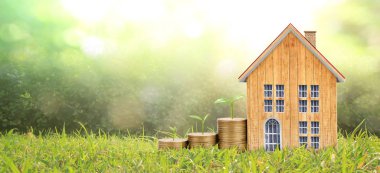 Bozuk paraların üzerinde madeni para yetiştirme evi. Yatırım önerisi kavramı