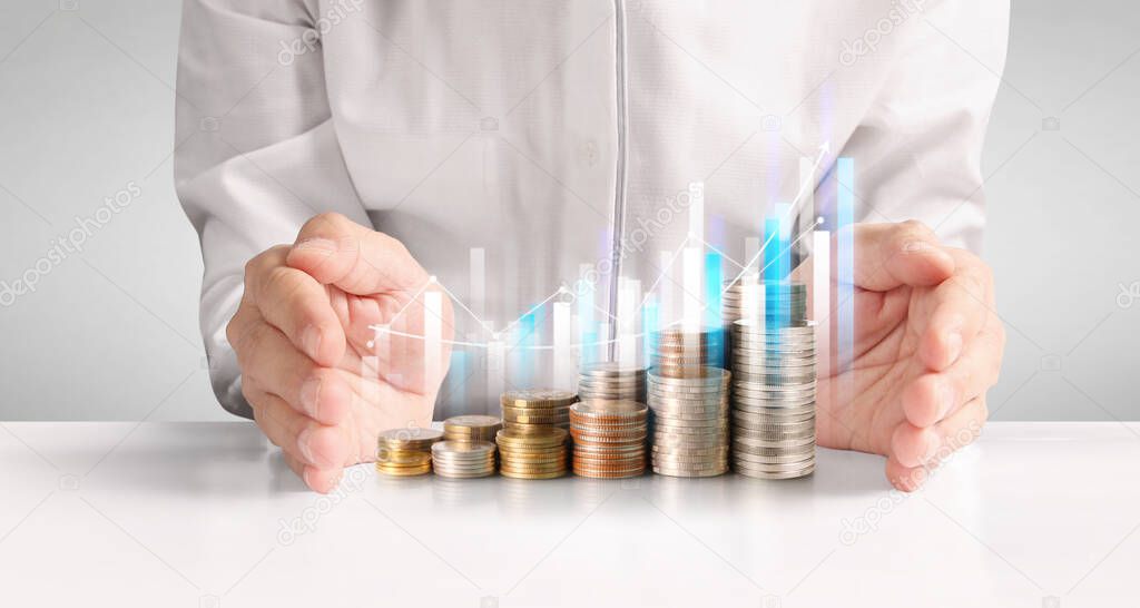 Coins stacked on each other in different positions,Man hand in business casual money
