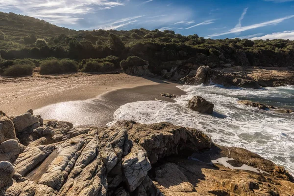 Waves wash onto a small sandy cove near Calvi in Corsica — Stock Photo, Image