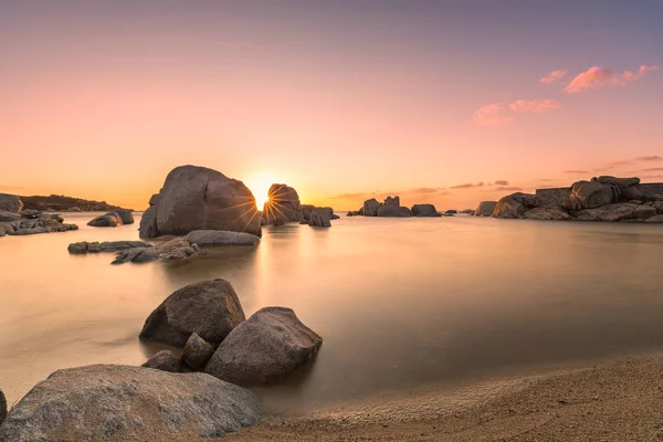 Sunrise over boulders and beach on Cavallo Island in Corsica — Stock Photo, Image
