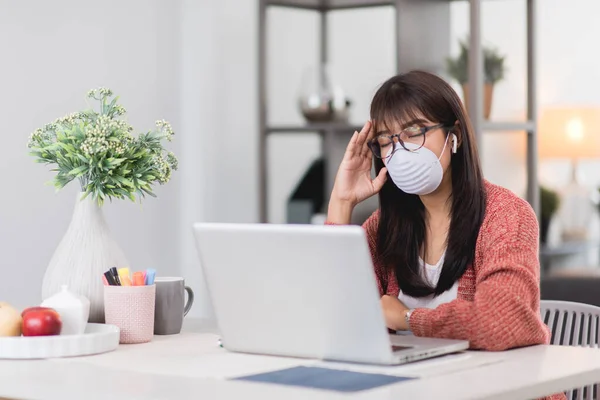 Young Asian Woman Wearing Medical Mask Working Laptop Remotely Work Royalty Free Stock Images