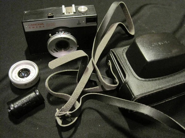 Old black camera with accessories on black background. — Stock Photo, Image