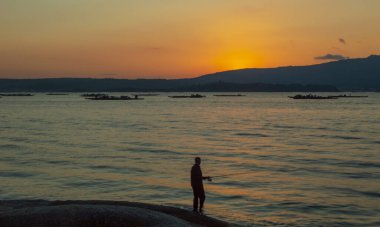 Sahilde bir adamın silueti.