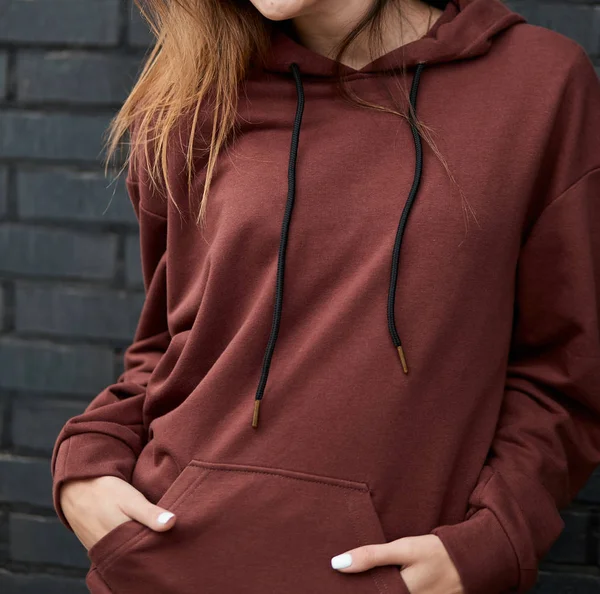 young girl wears brown hoodie