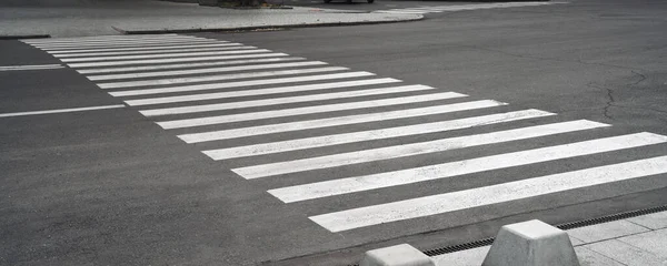 pedestrian crossing during day. pedestrian lanes on asphalt.