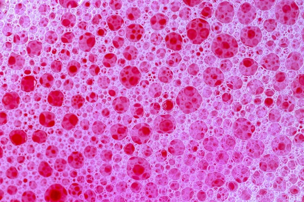 Espuma rosa e bolhas. Textura de fundo. Vista de perto de sabão — Fotografia de Stock