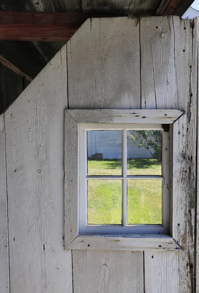 Square window in rustic barn door