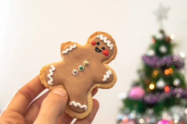 Close Hand Holding Homemade Christmas Cookie Blurred Christmas Tree Lights — Stock Photo, Image