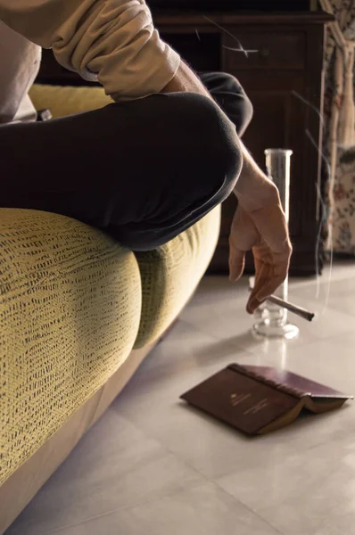 Man Sitting Sofa Smokes Joint Reading Book Smoking Marijuana Home — Stock Photo, Image