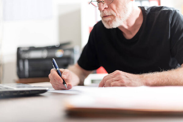 Man working in office, hard light effect