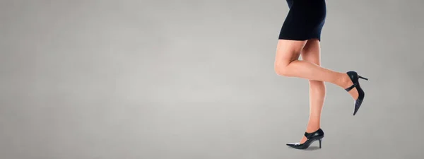 Woman legs with black short dress — Stock Photo, Image