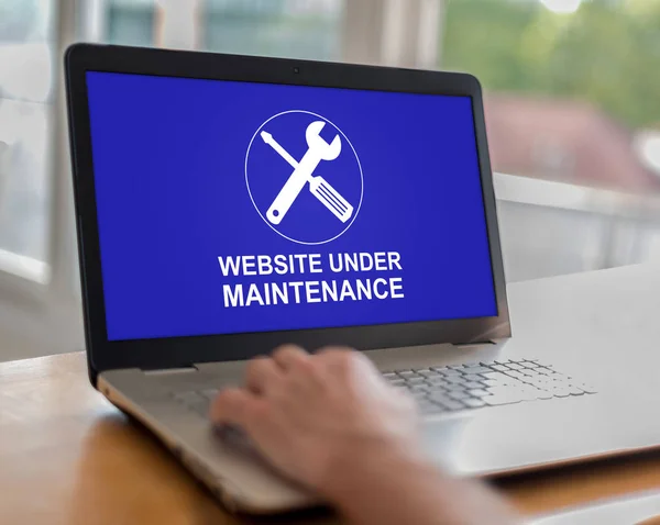 Website maintenance concept on a laptop — Stock Photo, Image