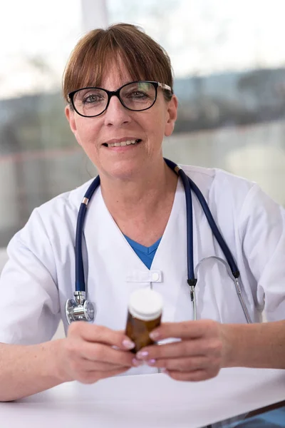 Portrait of female doctor checking medicine — Stock Photo, Image