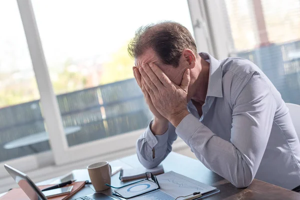 Uomo d'affari stressato seduto in ufficio — Foto Stock