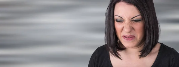 Young woman with an expression of disgust — Stock Photo, Image