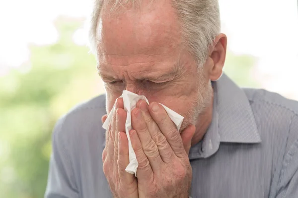 Man blowing his nose