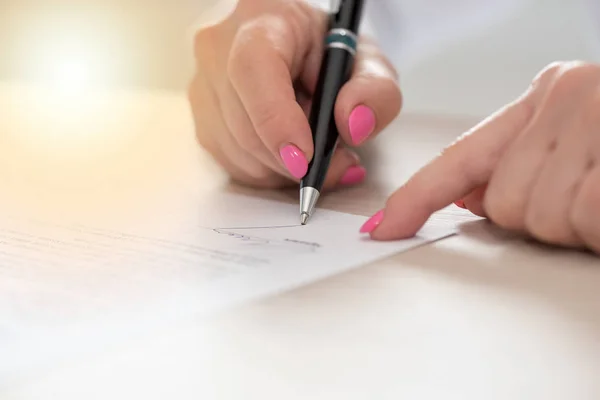 Woman signing a contract, light effect — Stock Photo, Image