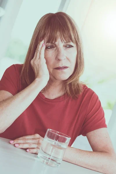 Mature woman having a headache — Stok fotoğraf