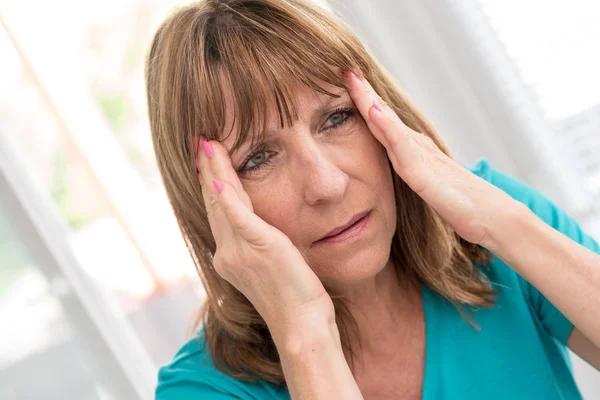 Mature woman having a headache — Stock Photo, Image