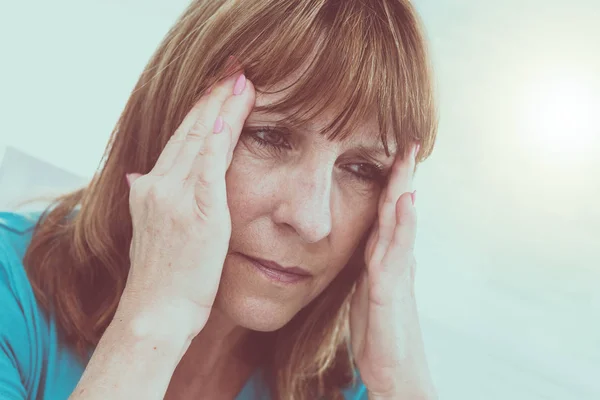 Mature woman having a headache — Stok fotoğraf