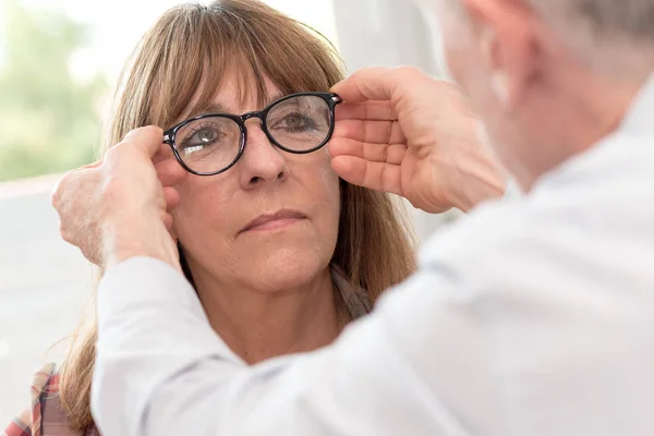 Ώριμη γυναίκα δοκιμές νέα γυαλιά — Φωτογραφία Αρχείου