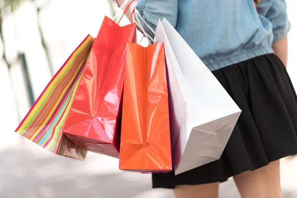 Mulher andando e segurando sacos de compras — Fotografia de Stock