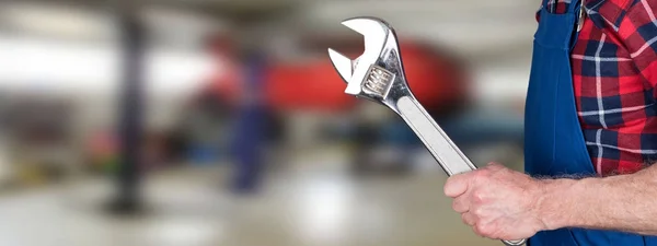 Car mechanic holding wrench — Stock Photo, Image