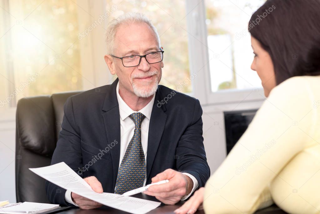 Woman meeting financial adviser in office, light effect